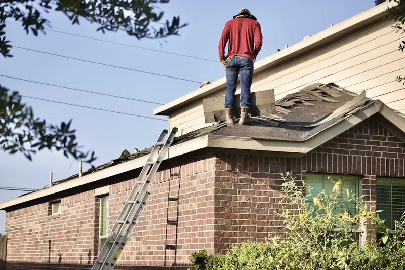 Professional roofer working on a residential roof in Merrywoods